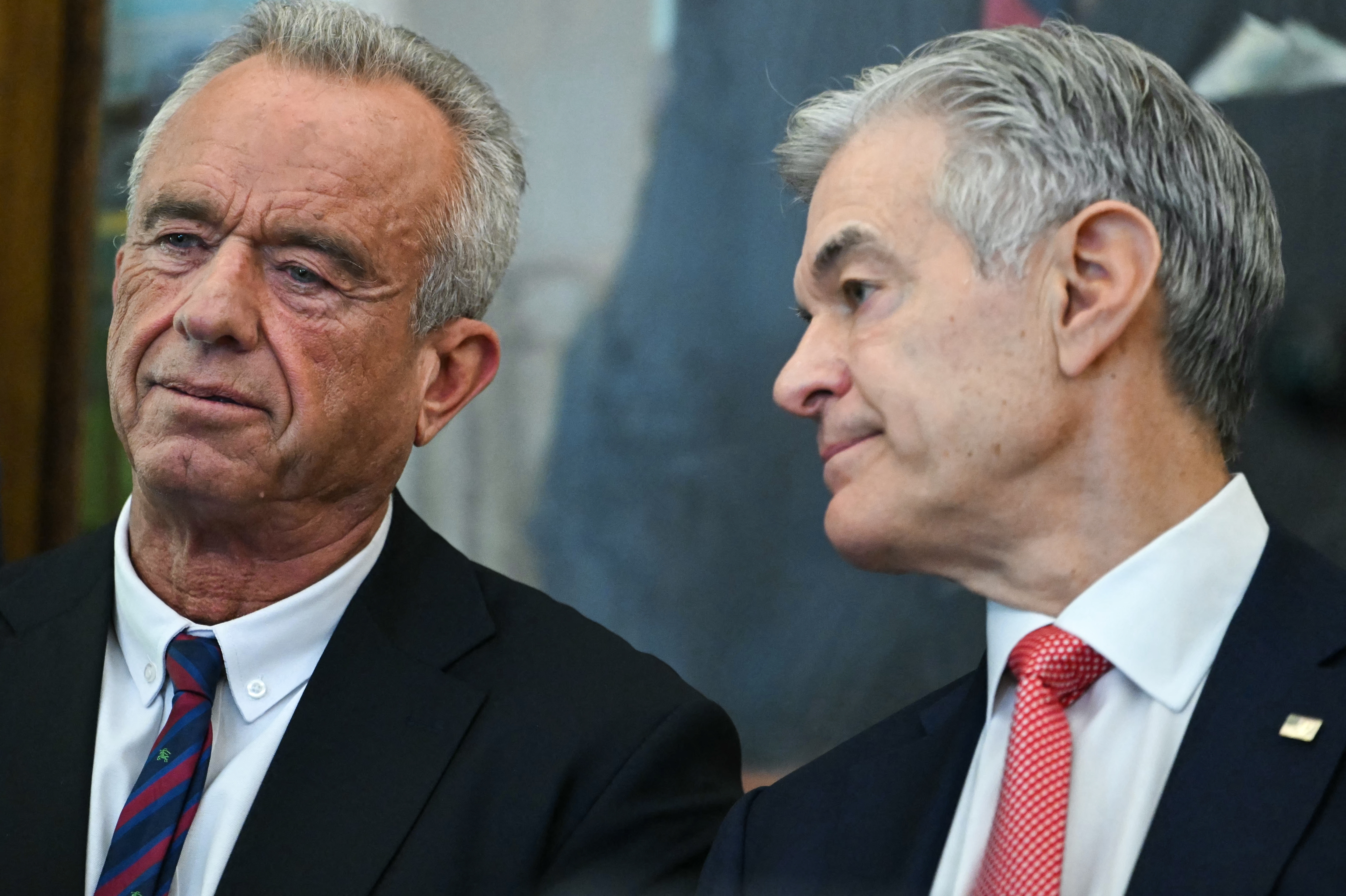 Health Secretary Robert F. Kennedy Jr. and Medicare and Medicaid Administrator Dr. Mehmet Oz (right) will announce new restrictions to gender-affirming care for minors Thursday. (AFP via Getty Images)