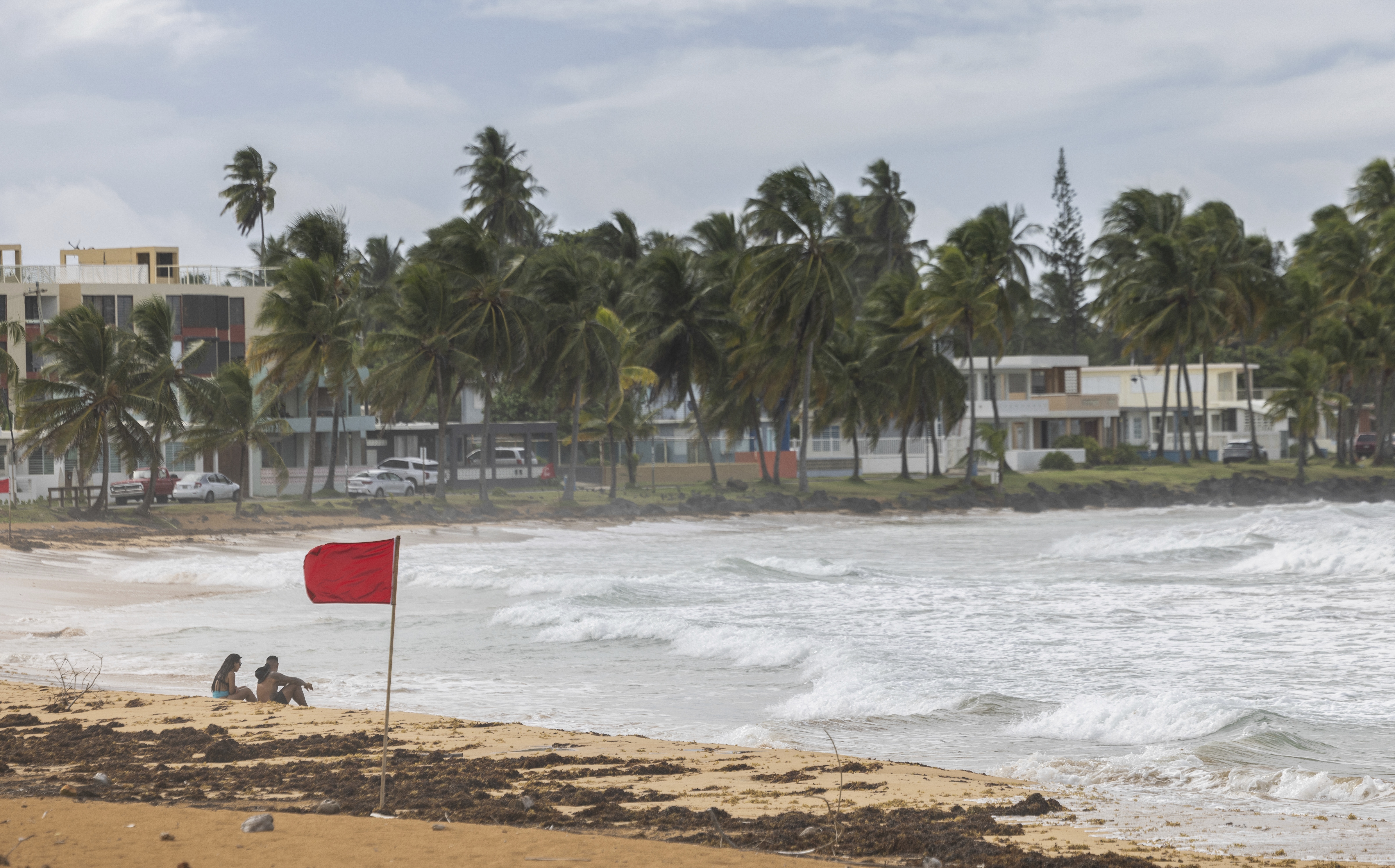 Ernesto, now a hurricane, is drenching Puerto Rico and knocking out power