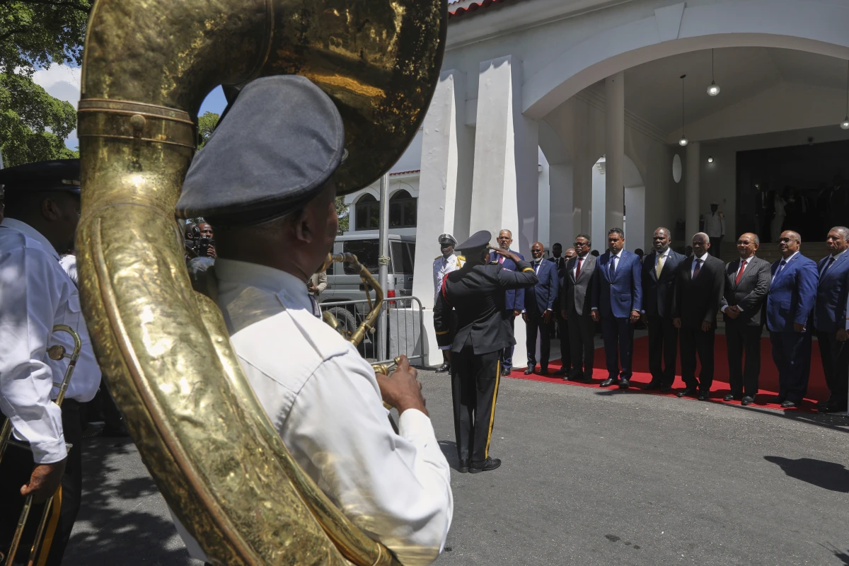Transitional presidential council members listen to Haiti's national anthem during the installation ceremony of Laurent Saint-Cyr as the new president of the council in Port-au-Prince, Haiti, Thursday.