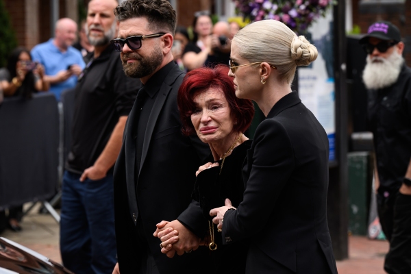 From left: Jack, Sharon and Kelly Osbourne leave after viewing tributes to the late Ozzy Osbourne from fans as his funeral cortege travels through his home city of Birmingham, England, on Wednesday.