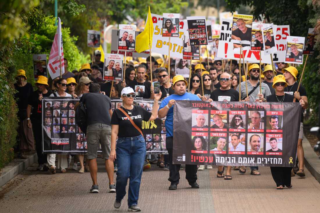 Residents, family members and friends of those killed or taken hostage gather to mark the one year anniversary of the attacks by Hamas, on October 7 in Be'eri, Israel.