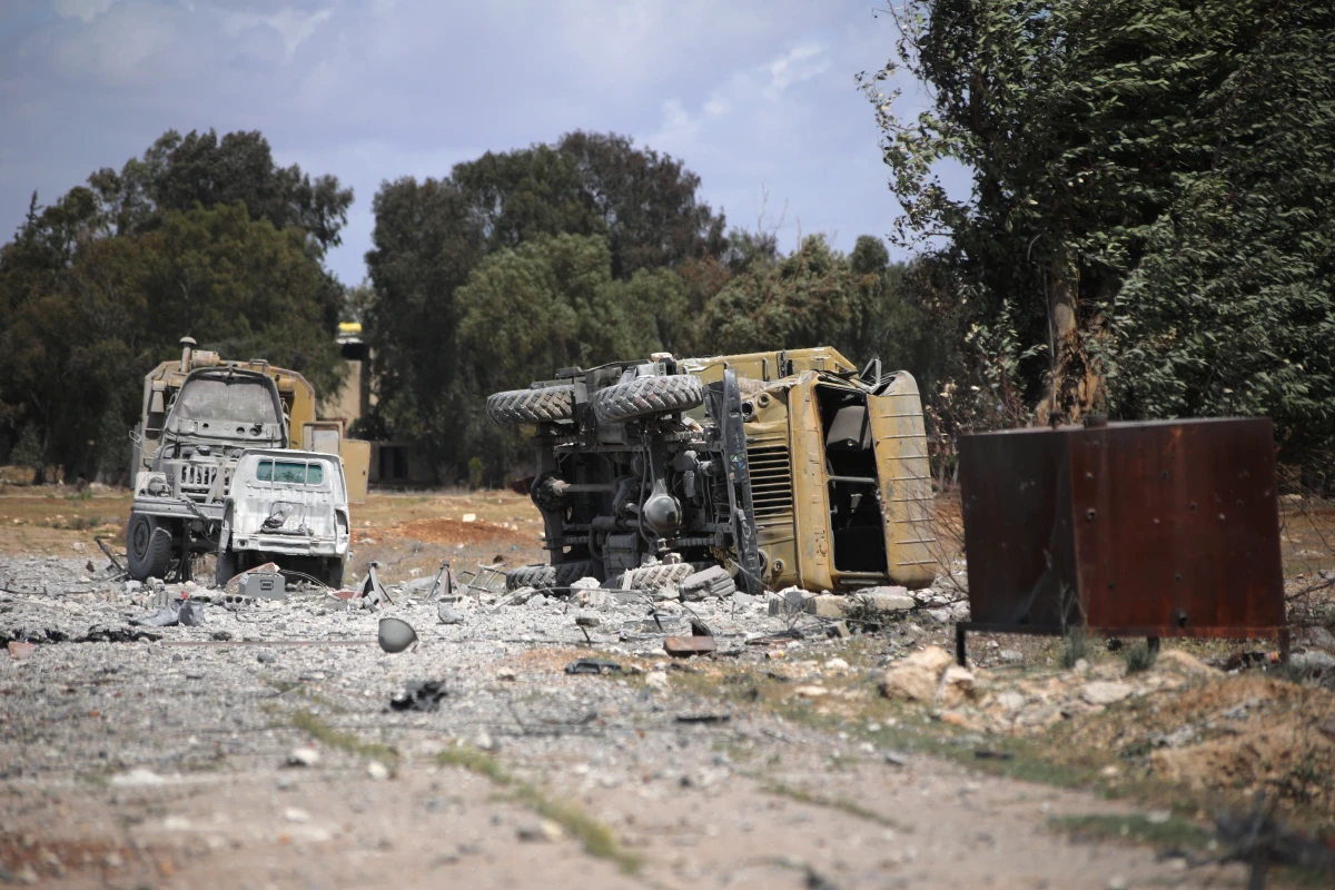 Debris and military vehicles lie at the scene of an Israeli strike in Syria's Hama province on April 3.