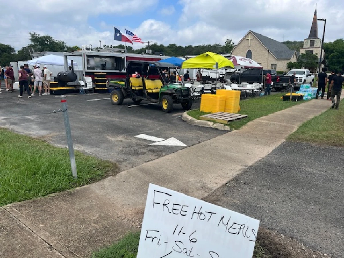 Volunteers from other parts of Texas have set up mobile kitchens dispensing free meals at several locations around the flood zone, including the parking lot of Hunt United Methodist Church