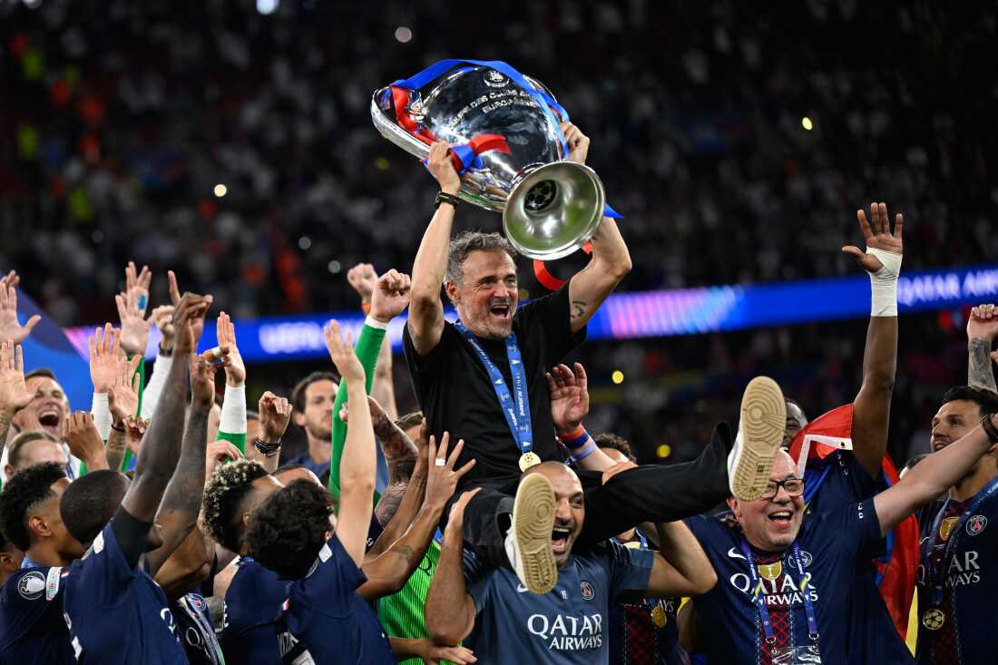 PSG's head coach Luis Enrique, top, celebrates with players after winning the Champions League final soccer match against Arsenal in Budapest, Hungary, Saturday, May 30, 2026.