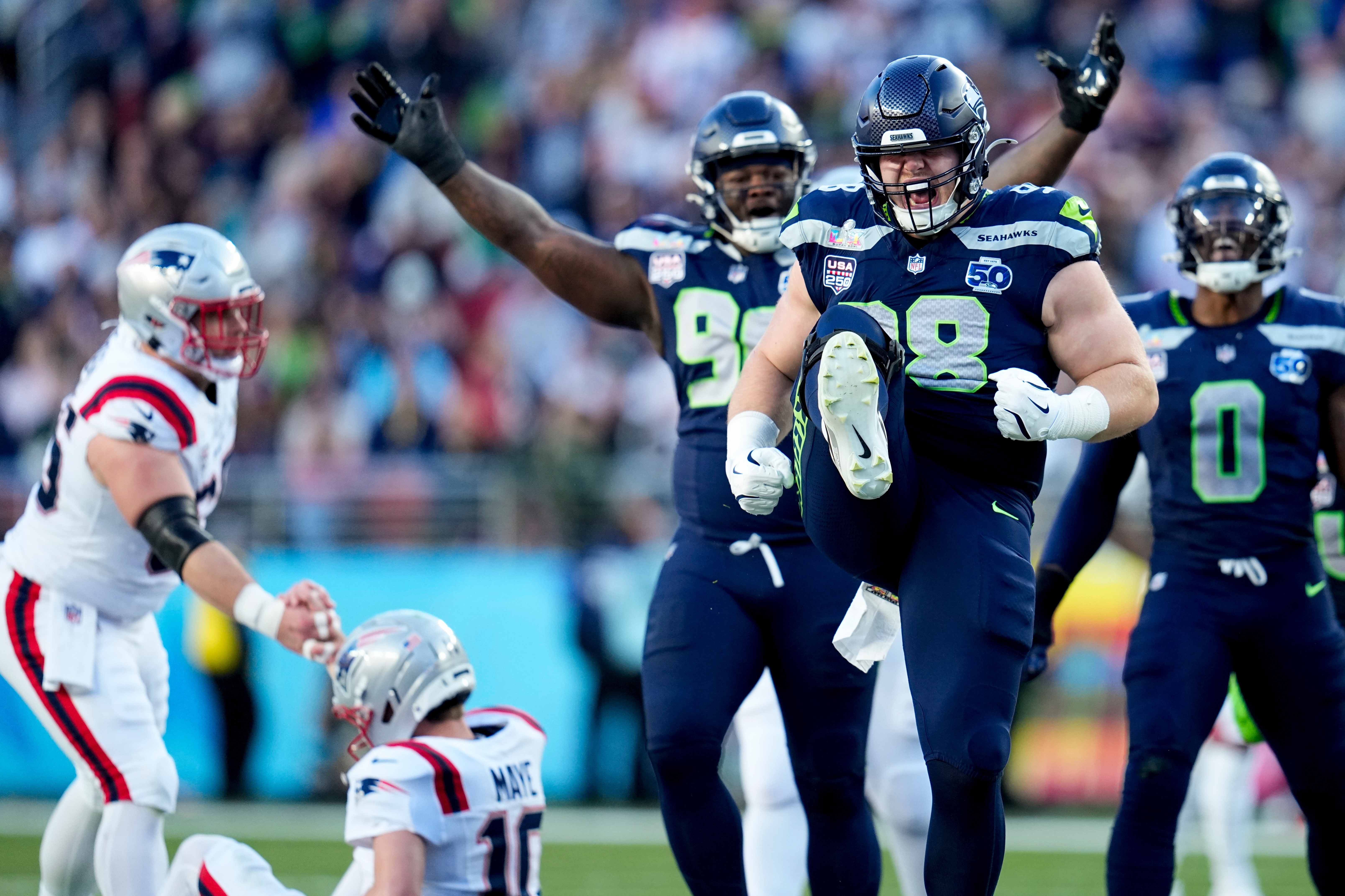 Seattle Seahawks defensive end Rylie Mills (98) celebrates after sacking New England Patriots quarterback Drake Maye during the first half of the NFL Super Bowl 60 football game, on Sunday in Santa Clara, Calif.