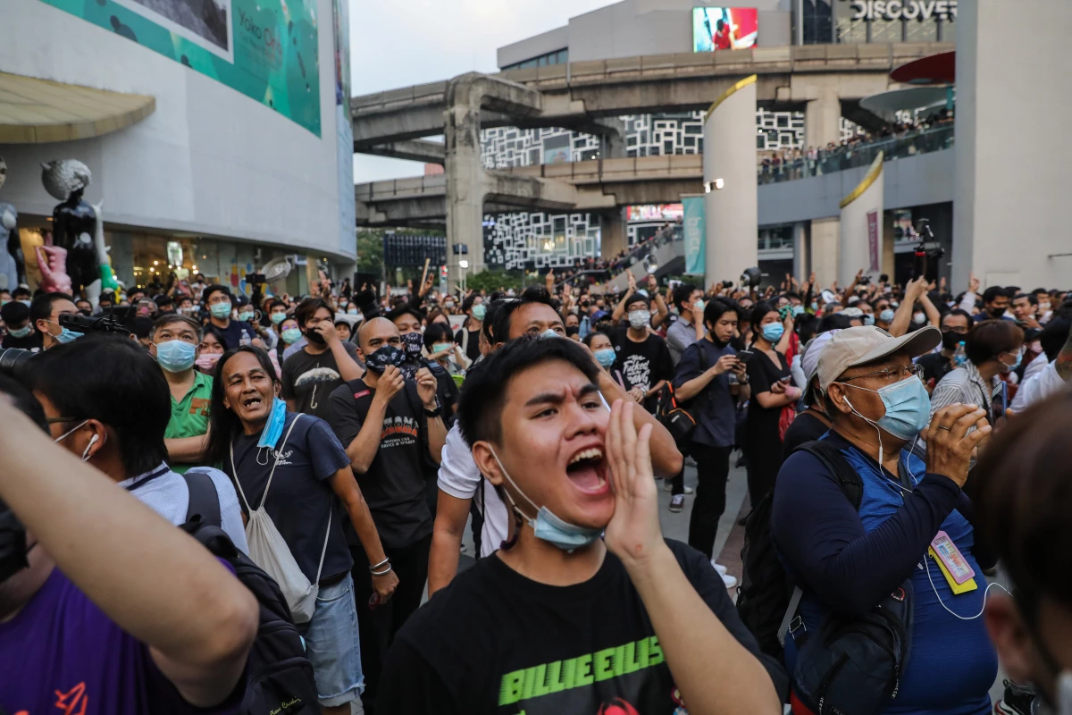 Thai protesters cheer during a pro-democracy rally at the Pathumwan Intersection on Feb. 10, 2021, in Bangkok, Thailand. Protesters descended on a shopping mall in central Bangkok to stage a 'make noise' campaign.