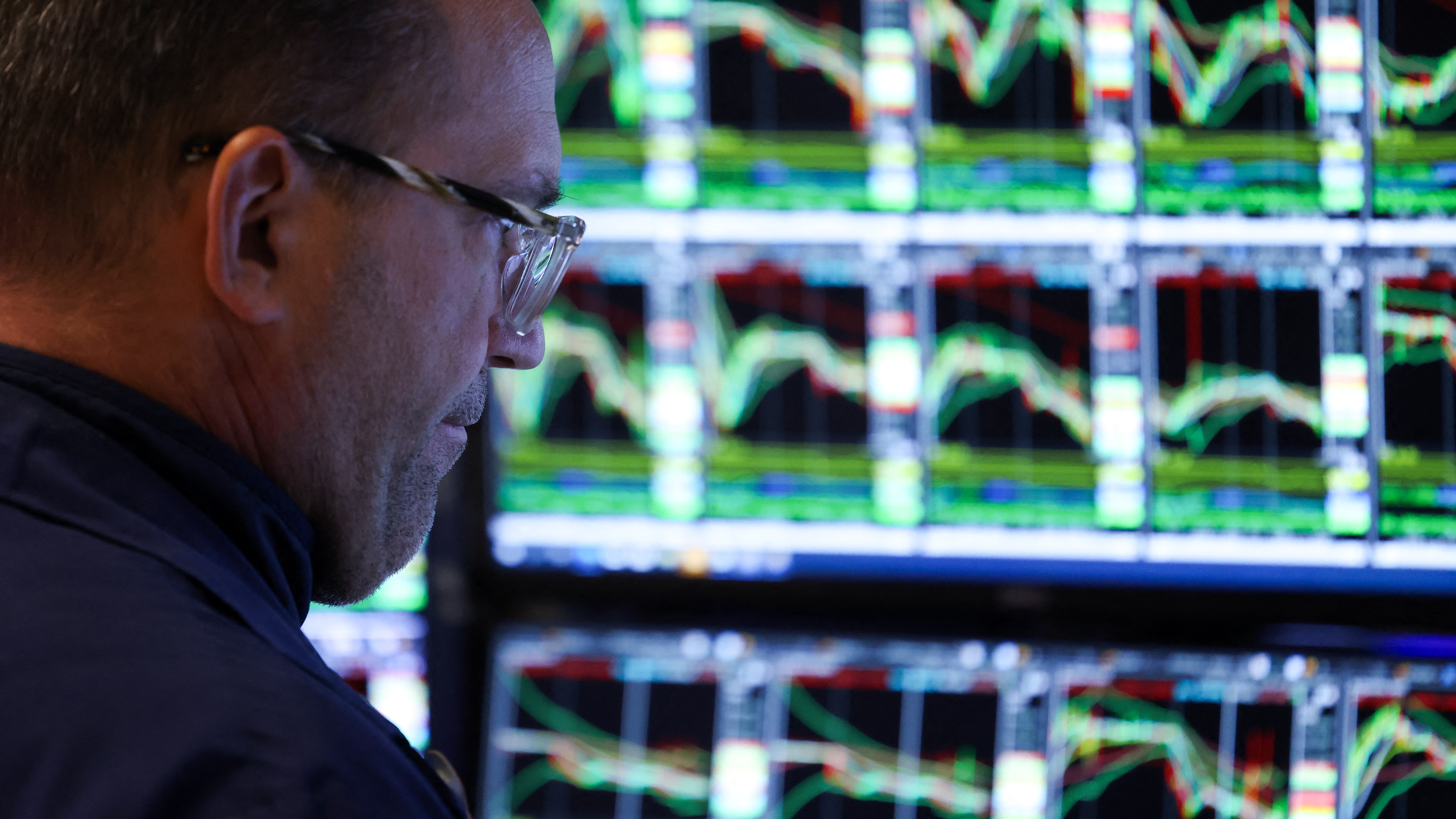 A trader works on the floor of the New York Stock Exchange (NYSE) at the opening bell in New York City on March 10, 2025.