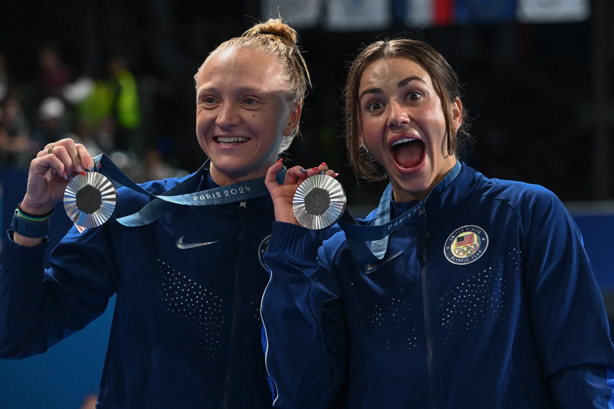 The United States won its first medals at the Paris Olympic Games when Kassidy Cook and Sarah Bacon took silver in the synchronized 3m springboard final on Saturday. Cook (right) and Bacon pose after the competition at the Aquatics Center in Saint-Denis, north of Paris.
