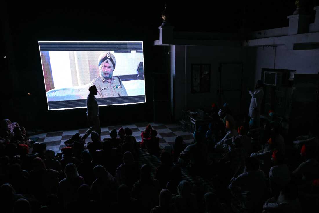 This photograph taken on July 15, 2026 shows villagers watching the film 'Satluj' during a community-led screening at the Gurudwara Singh Sabha in Punjab's Gurdaspur city. Across Punjab, Sikh religious bodies and political groups have been hosting Satluj film screenings in temple courtyards, community halls and village squares with viewer numbers swelling.