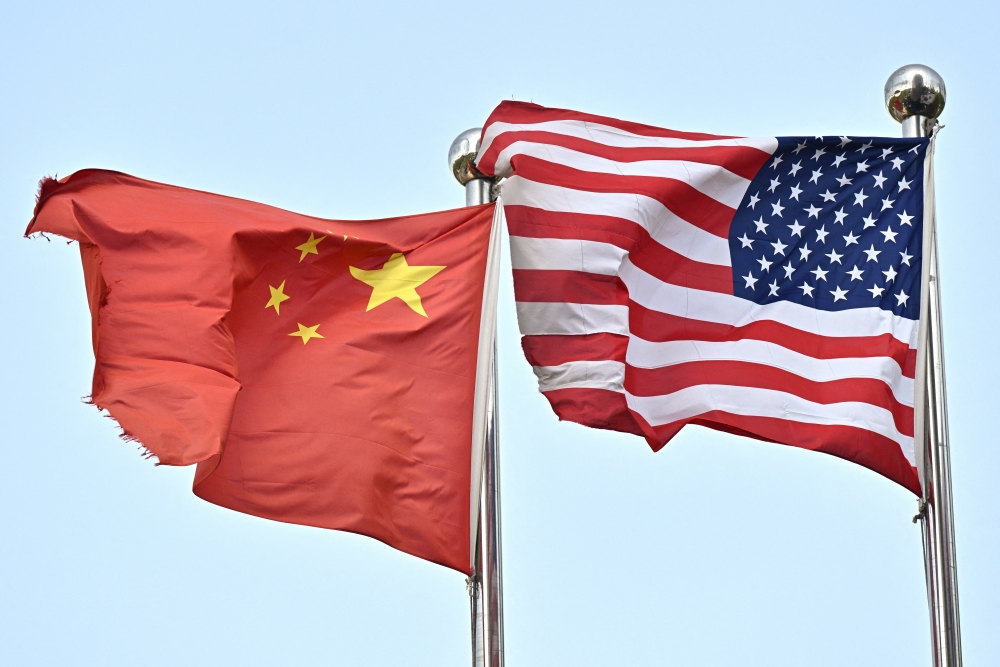 Chinese and U.S. flags wave outside a technology company in Beijing, China. (AFP via Getty Images)