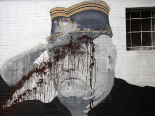 A mural of former Bosnian Serb military chief Ratko Mladic vandalized with paint in Belgrade, Serbia, Sept. 20, 2022.
