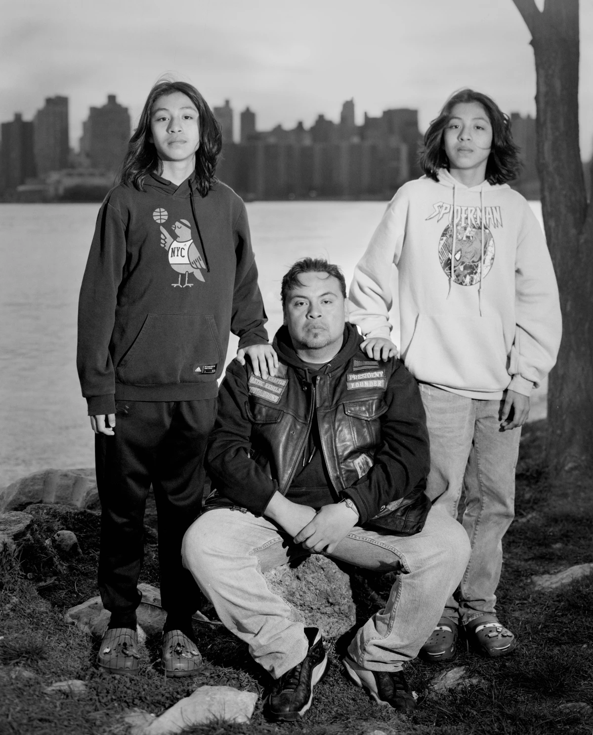 Eddie Lucero, the club's president, poses for a portrait with his twins, Eddie and Ethan, during an Easter egg hunt on Randall's Island for the Aztec Rebels and their families.