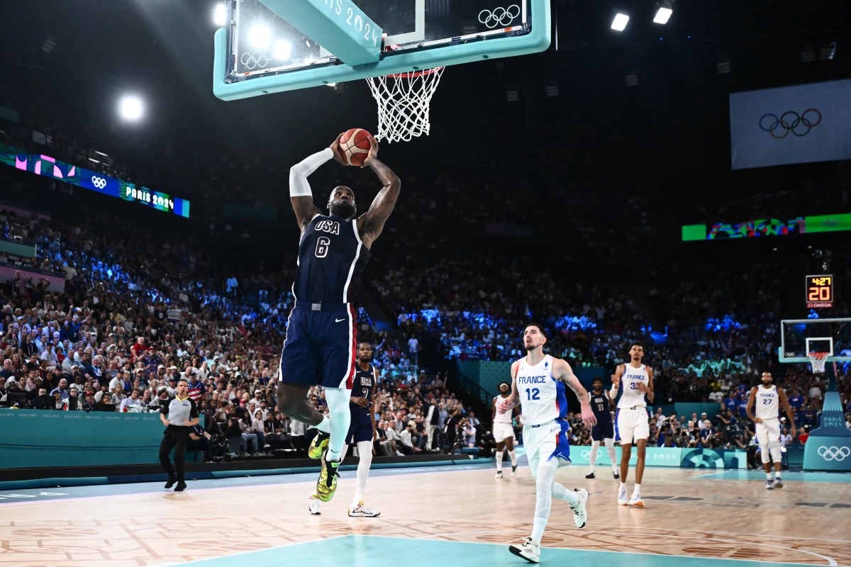LeBron James dunks the ball during the men's Gold Medal basketball match between France and USA at the Paris Olympics on Saturday.