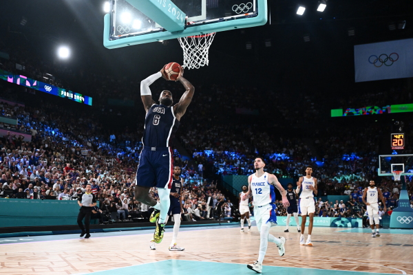 LeBron James dunks the ball during the men's Gold Medal basketball match between France and USA at the Paris Olympics on Saturday.