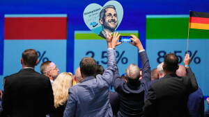 AfD supporters celebrate with a sign featuring top candidate Ulrich Siegmund after the first results of the Saxony-Anhalt state election at the party’s election night gathering in Magdeburg, Germany, Sunday, Sept. 6, 2026.