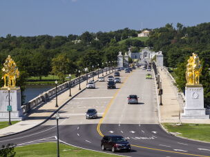 Drivers cross the Memorial Bridge on the Virginia side of the span. In the foreground is a sliver of Memorial Circle. In the distance is Arlington Cemetery and Arlington House, former home of Confederate Gen. Robert E. Lee.