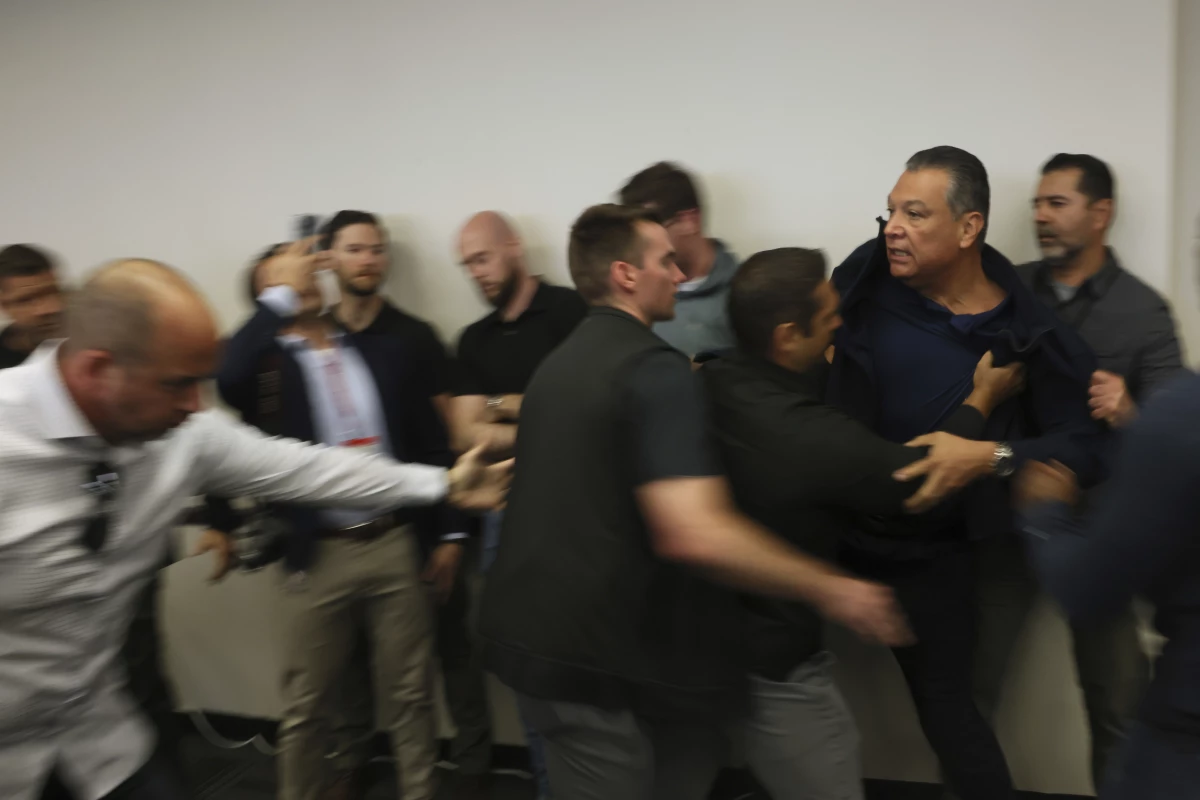 Sen. Alex Padilla, D-Calif., is pushed out of the room as Homeland Security Secretary Kristi Noem holds a news conference regarding the recent protests in Los Angeles on Thursday, June 12.