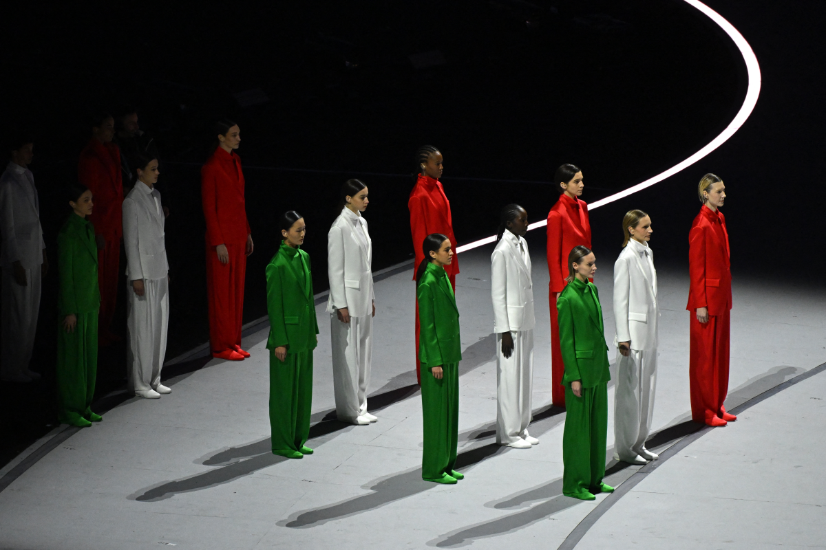 Performers dressed in the colors of the Italian flag line up during the opening ceremony.
