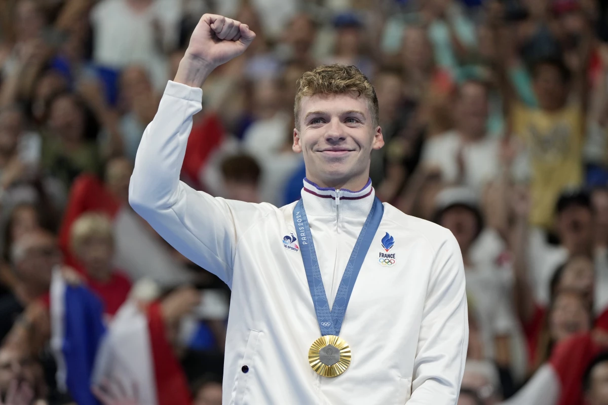 Leon Marchand, of France, celebrates after receiving his first gold medal in the men's 400-meter individual medley final at the 2024 Paris Summer Olympics on Sunday in Nanterre, France.