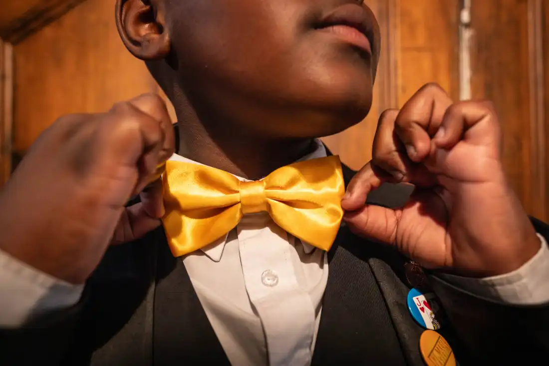 Aspiring magician Lubelo Mthenjana adjusts his bowtie at the Cape Town College of Magic in the Claremont neighbourhood of Cape Town, South Africa. Many of the college's students sport bow-ties, magician's hats or other attire asosciated with stage magic.