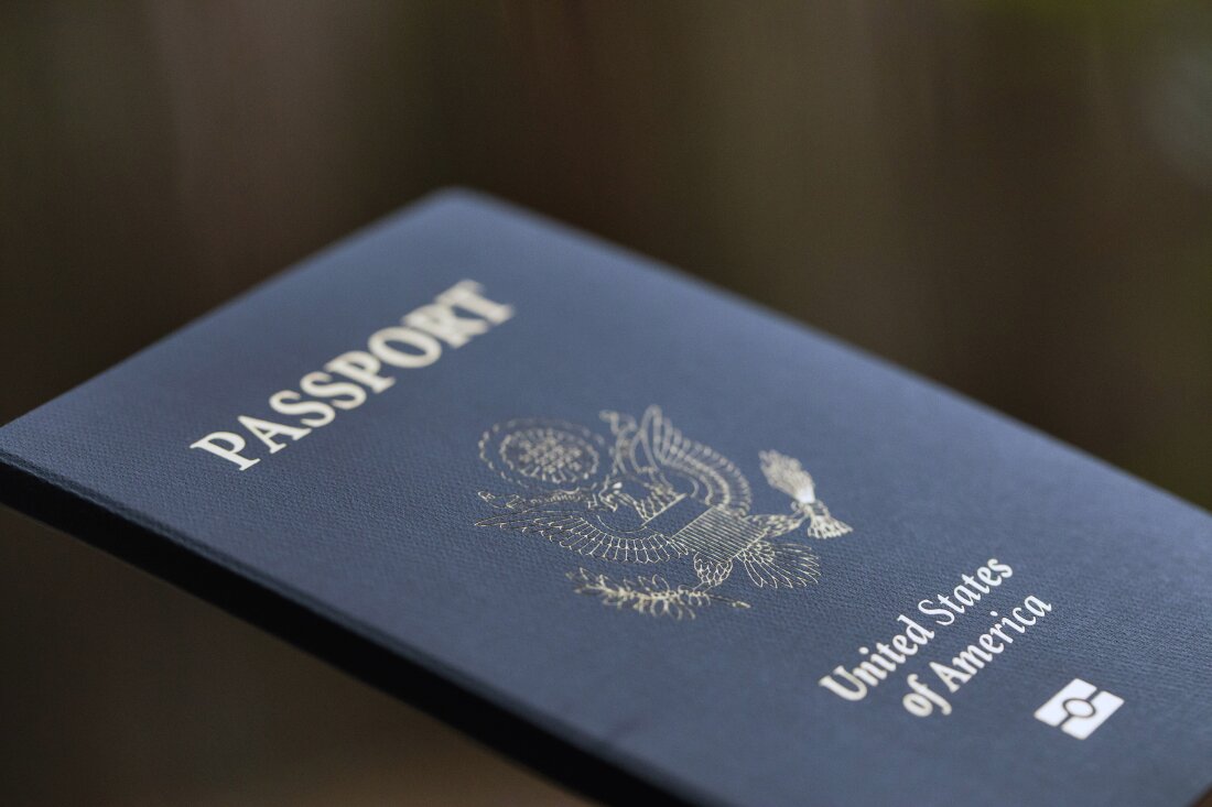 The cover of a U.S. Passport is displayed in Tigard, Ore., Dec. 11, 2021. Americans can now renew their passports online, bypassing a cumbersome mail-in paper application process that often caused delays. The State Department announced Wednesday that its online passport renewal system is now fully operational.