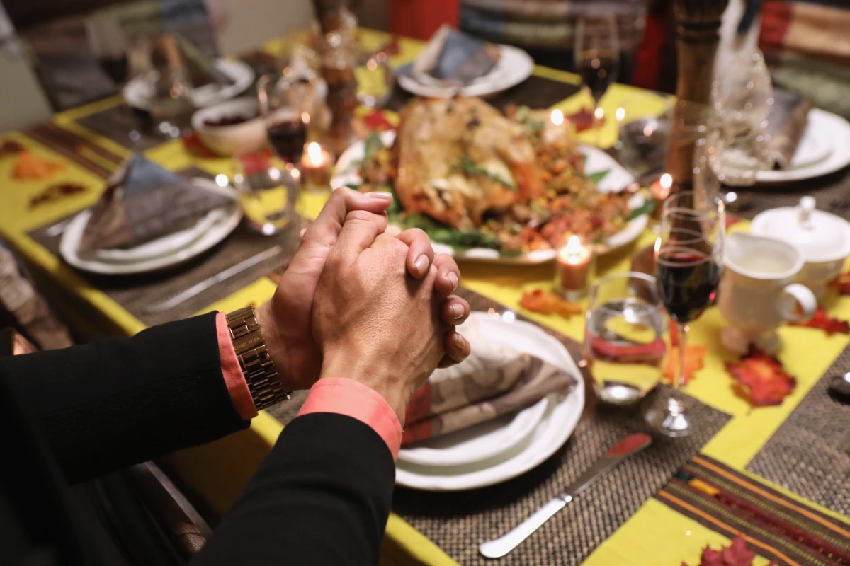 Central American immigrants and their families pray before Thanksgiving dinner on Nov. 24, 2016 in Stamford, Connecticut.