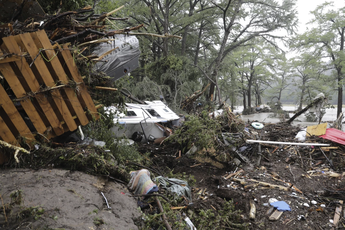 Damaged vehicles and debris are seen roped off near the banks of the Guadalupe River after flooding in Ingram, Texas, on Friday.