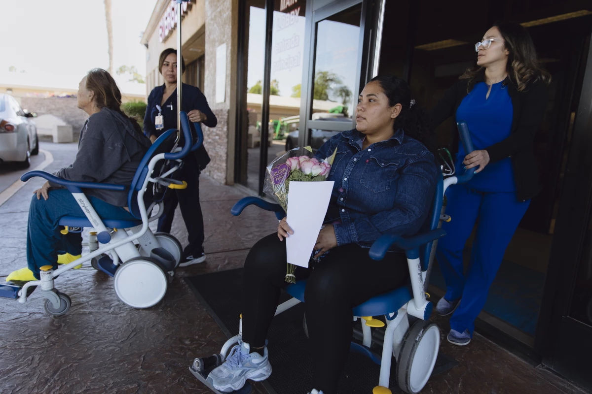 Outside John F. Kennedy Memorial Hospital in Indio, Calif., Yasmelin Valazquez waits for her partner to bring the car around on April 9, 2025.
