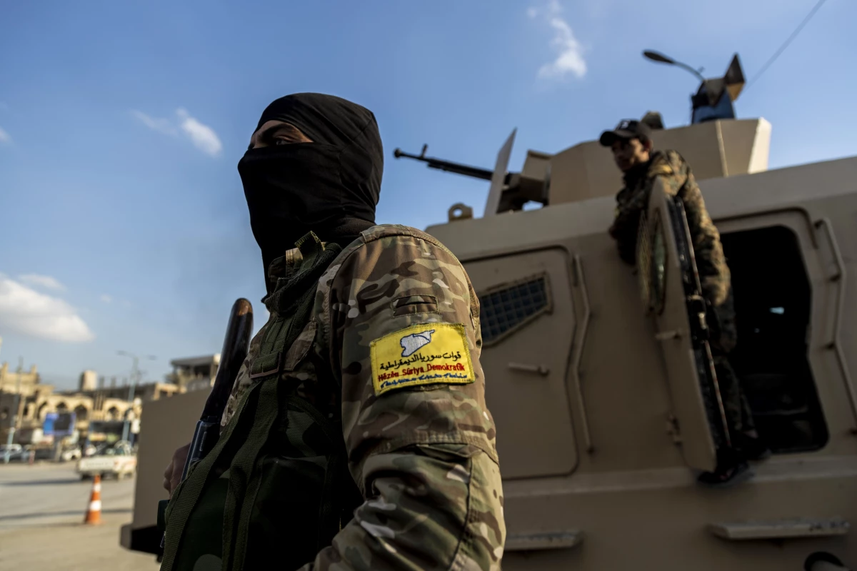 U.S.-backed Syrian Democratic Forces (SDF) fighters stand guard at Al Naeem Square in Raqqa, Syria, in February 2022.