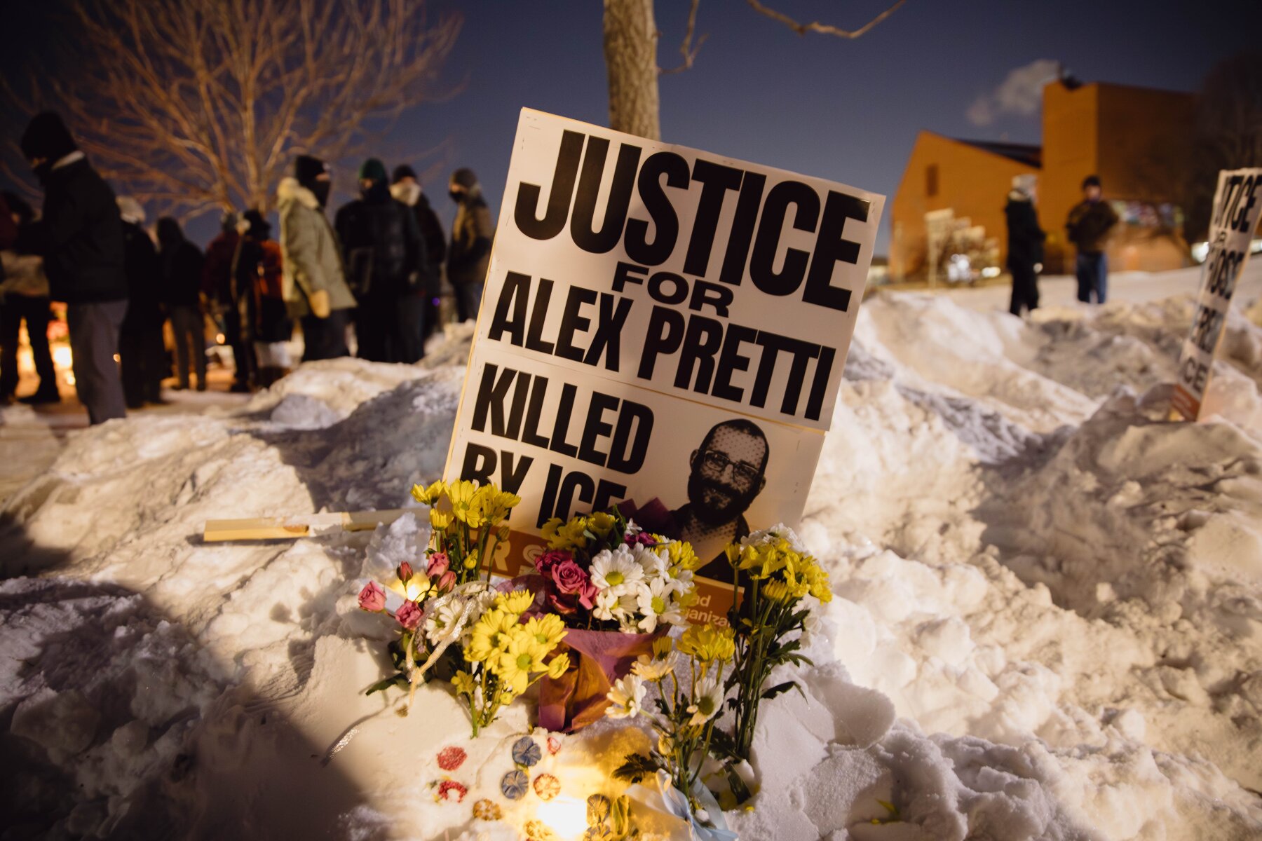 A sign⁤ for Alex Pretti, who was killed earlier in the day by‌ a‍ U.S. Border Patrol officer, is​ displayed during a vigil Saturday in Minneapolis.