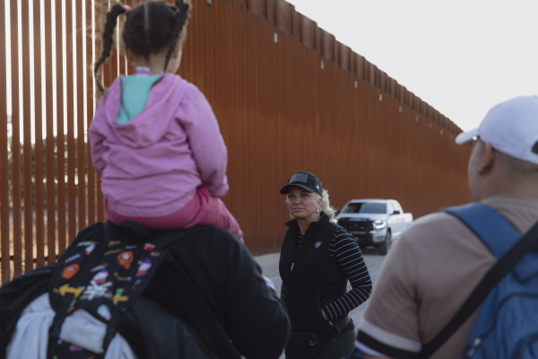 Kate Monroe speaks to migrants at the southern border in Jacumba Valley, California, after they crossed into the U.S. on Dec. 8, 2024. Zaydee Sanchez for NPR