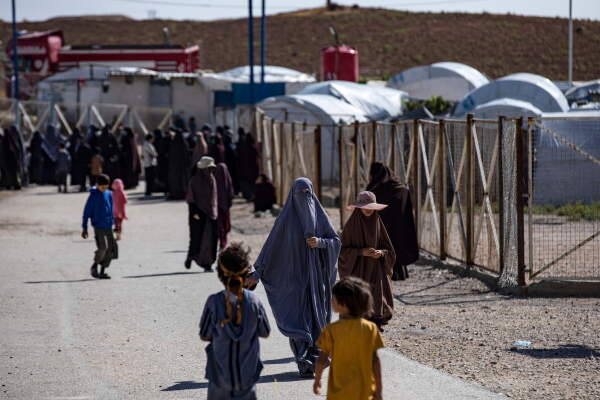 Women and children walk at Camp Roj, where relatives of people suspected of belonging to the Islamic State group are held, in Syria's northeastern Hasakah province in October 2023.