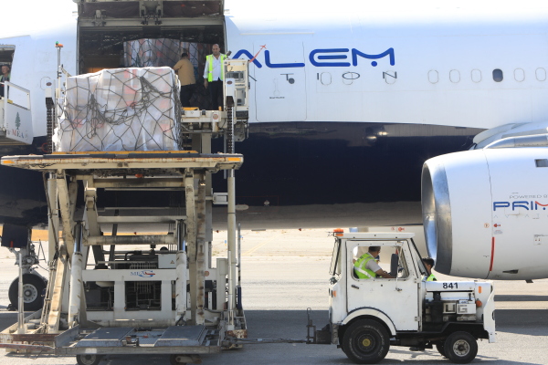 Workers unload medical supplies delivered by the World Health Organization as a prevention of any potential health crisis that might result from a major conflict in Lebanon, at Beirut International Airport Monday.