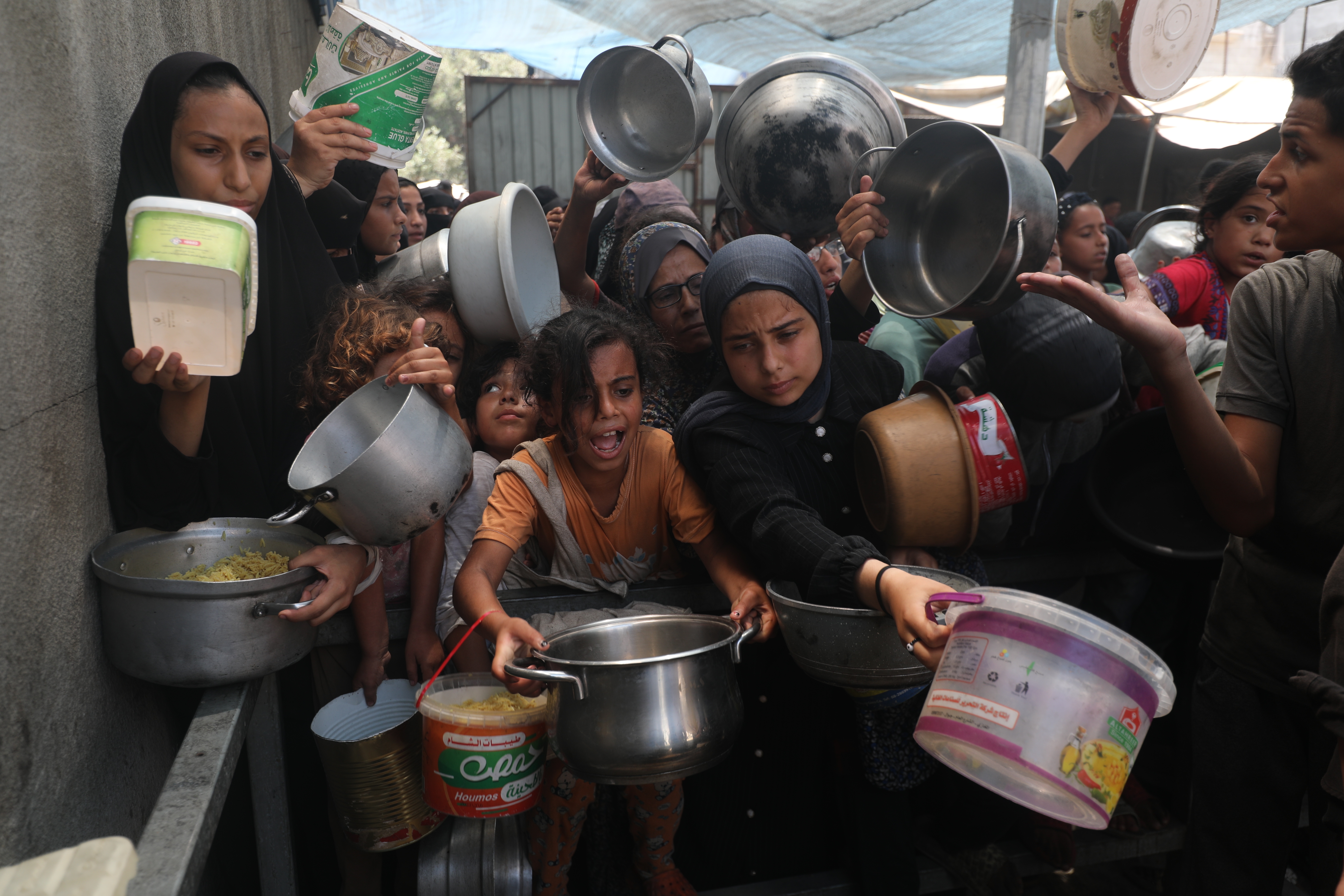 Palestinians, including children, who are struggling to access food due to Israel