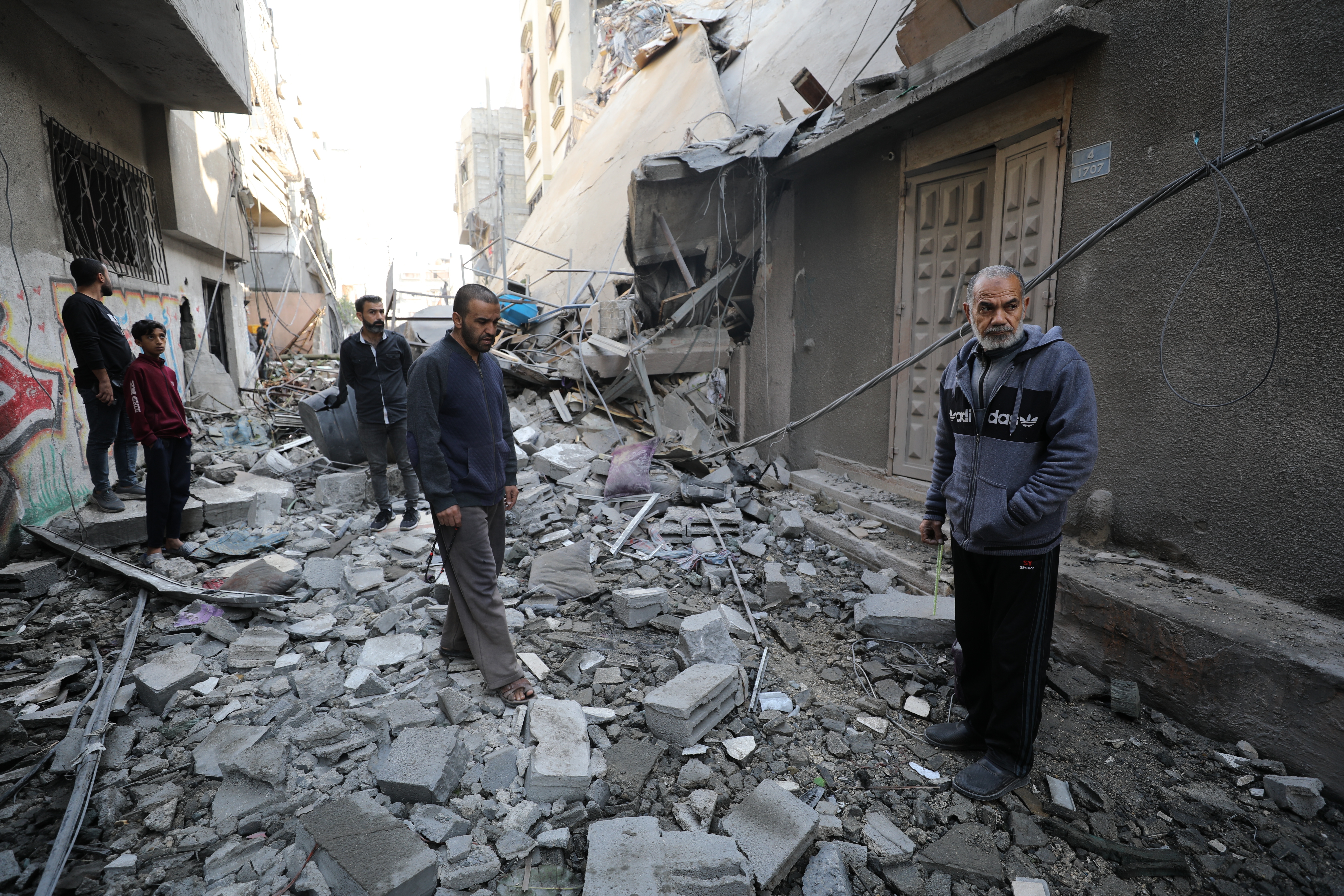 Palestinians inspect damage following an Israeli airstrike that hit a home in the north of Gaza City on Thursday.