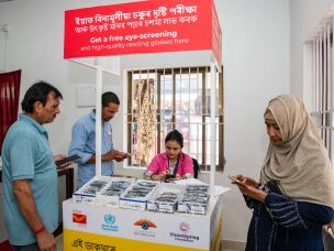 Sangita Kalita, an eye screening volunteer, helps clients at the Rangia Post office.<br>
