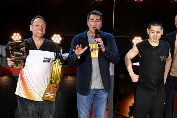 (L-R) Joey Chestnut, Rob Riggle and Takeru Kobayashi speak onstage during LIVE Chestnut vs. Kobayashi: Unfinished Beef at the Hyper X Arena at the Luxor in Las Vegas, Nevada, on Monday.