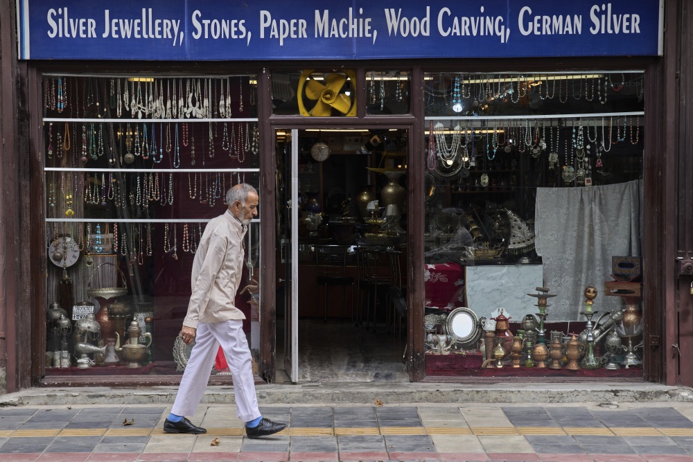 A Kashmiri man walks past a shop displaying stone jewelry and Kashmiri handicrafts in Srinagar, in Indian-controlled Kashmir. (AP)