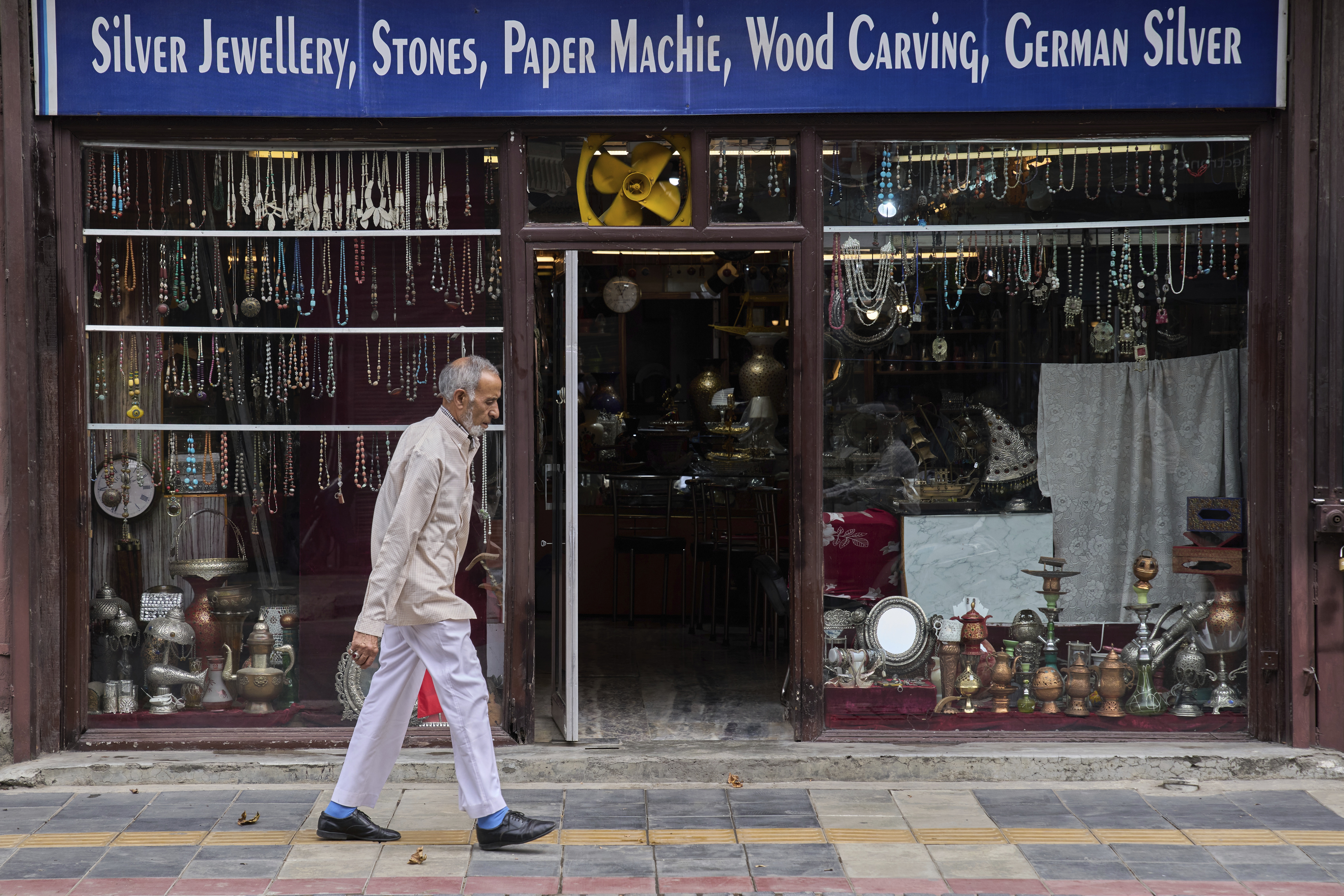 A Kashmiri man walks past a shop displaying stone jewelry and Kashmiri handicrafts in Srinagar, in Indian-controlled Kashmir. (AP)