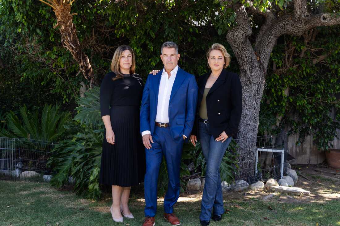 This photo shows, standing from left to right, Suzi Emmerling, Jeremy Bernard and Naomi Seligman. They are outdoors, standing on green grass; a few trees are behind them. Emmerling is wearing a black dress; Bernard is wearing a blue suit; and Seligman is wearing blue jeans and a black blazer. This photo shows, standing from left to right, Suzi Emmerling, Jeremy Bernard and Naomi Seligman. They are outdoors, standing on green grass; a few trees are behind them. Emmerling is wearing a black dress; Bernard is wearing a blue suit; and Seligman is wearing blue jeans and a black blazer.