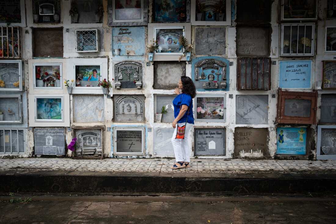 Yolanda Rocha, a victim of extrajudicial disappearance, searches for her brother's body in the Central Cemetery of Neiva, Huila, Colombia, on April 30, 2025. For the first time in the history of the conflict, former military personnel responsible for the so-called 'false positives' participate in forensic interventions to search for the disappeared of this crime, as part of the sanctions of the Special Jurisdiction for Peace (JEP). Photo: Nathalia Angarita for NPR
