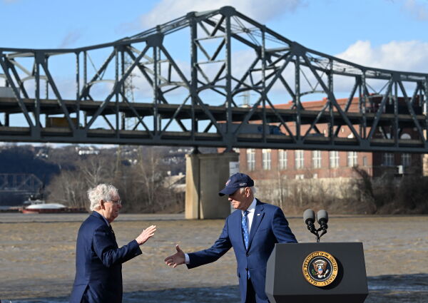 Former President Biden shakes hands with Republican Sen. Mitch McConnell during an event related to the Bipartisan Infrastructure Law in Covington, Kentucky, in 2023.