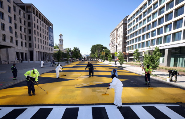 City workers repaint Black Lives Matter Plaza on May 13, 2021.