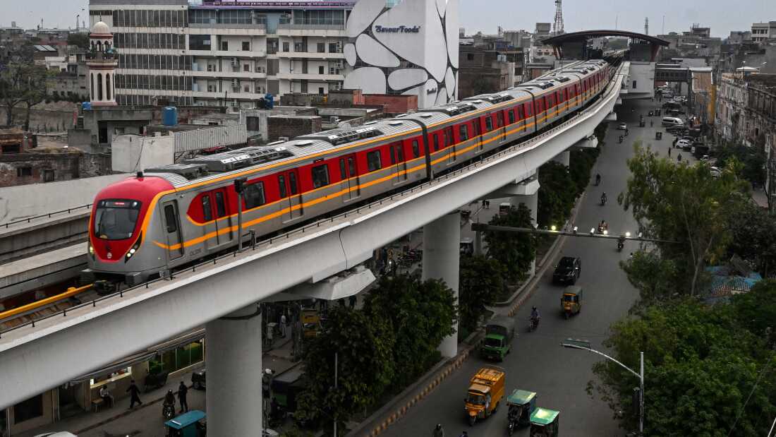 A metro train glides along an elevated track in Lahore.