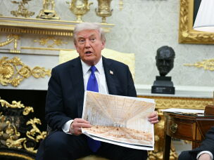 President Trump shows an image of his planned ballroom in the Oval Office on Oct. 22, 2025.