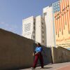 An Iranian woman walks past an anti-U.S. banner in Tehran on Sunday.