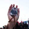 A person holds a photo of Iranian Supreme Leader Ayatollah Ali Khamenei, killed in joint US and Israeli strikes, as people mourn in a Tehran square on March 1, 2026.