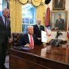 President Donald Trump, joined by Health and Human Services Secretary Robert F. Kennedy Jr. (L) and Commerce Secretary Howard Lutnick (R), signs an executive order on February 25, 2025 on price transparency requirements for the health care industry.