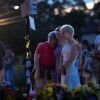 People gather at a memorial for victims of Wednesday's shooting at Annunciation Catholic Church in south Minneapolis. Two children were killed and 18 other people were injured.