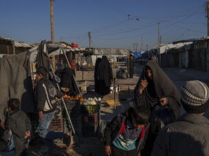 People stroll through the marketplace in the al-Hol detention camp on Jan. 30, 2025 in northeastern Syria's Hassakeh province, where tens of thousands of mostly women and children linked to ISIS have been living for years.